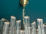 a chandelier made of clear glass hanging from the ceiling