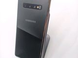 the back of a black samsung galaxy s10e phone sitting on top of a stand