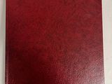 a red binder with a white label on it