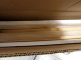 a cardboard box that has a bunch of wood sticks in it