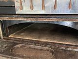 an old oven that is being used to cook food