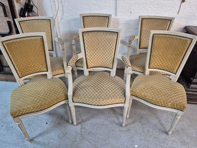 four chairs are lined up in a row on the floor