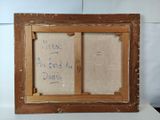 an old picture frame with writing on it sitting on top of a table
