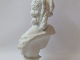 marble bust of a woman with flowers on her head on a pedestal
