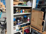 a tall cabinet with many items in it in a garage