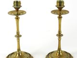pair of antique brass candlesticks on a white background