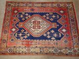 an old rug with a blue and red design on it