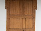 an old wooden door with a bird on top of it