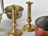 a lot of brass items that are sitting on a table