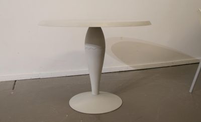 a white table with a white chair in front of it