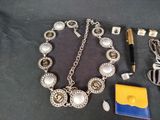 a necklace and other items laid out on a table