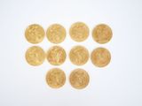 several gold coins are arranged in a heart shape on a white surface