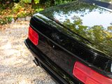 a black car that is parked on the side of the road