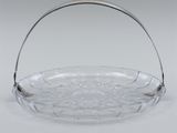 a clear glass basket with a handle and a metal handle
