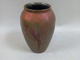 a vase that is sitting on a white surface