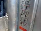 an image of a close up of a toilet with a safety sign on it