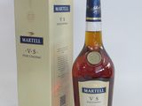 the bottle of marttilll v s is next to the box