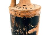 a black and white vase sitting on a white surface