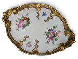 a plate with flowers painted on it on a white surface