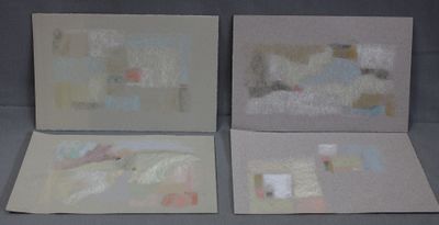 three paintings of different shapes and sizes are displayed on a gray surface