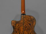 a close up of an acoustic guitar on a gray background