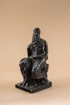 an image of a statue of a man sitting on a chair