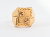 a close up of a gold ring with a square design on it