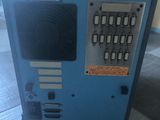 a blue machine sitting on a bed in a room