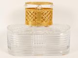 a close up of a clear glass box with a gold lid