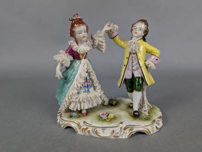 two figurines of a man and a woman on a table