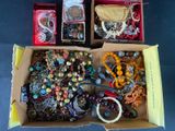 a box full of assorted jewelry sitting on a table