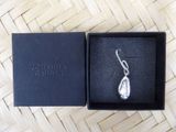 an image of a pair of earrings in a box on a table