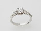 an engagement ring with a diamond center stone set in white gold