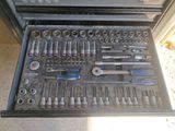 a drawer full of tools that are sitting on the floor