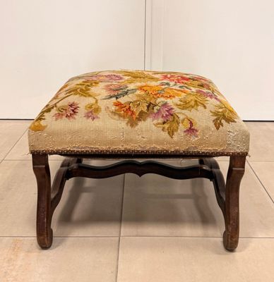 an upholstered foot stool with a floral design on it