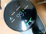 a digital clock that is on the side of a table