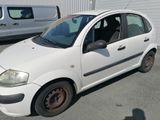 a picture of a small white car parked in a parking lot