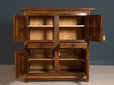 an old wooden cabinet with open doors and shelves in a room