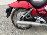 a red motorcycle that is parked on the side of the road