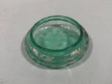 a small glass bowl with a green liquid inside of it