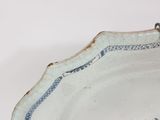 a blue and white plate with a fish design on it