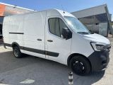 a white van parked in front of a building in a parking lot