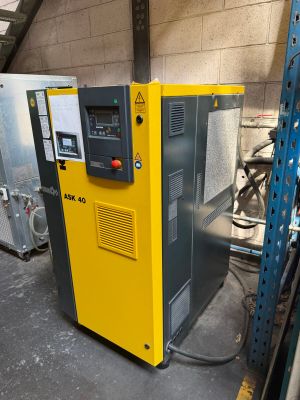 an image of a yellow machine in a warehouse with other machines
