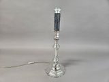 a silver and black lamp that is on a table