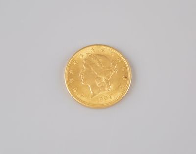 a close up of a gold coin on a white surface