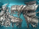 a lot of silver figurines in a blue tray
