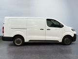 the white van is parked on the concrete floor in the room
