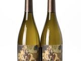deux bouteilles de vin blanc posées l'une à côté de l'autre sur une surface blanche