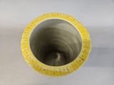 a close up view of a yellow pipe on a white surface