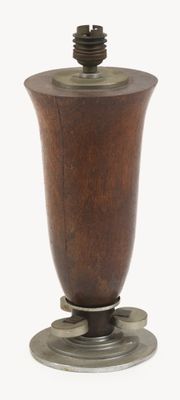 a small wooden vase with a metal base on a white background